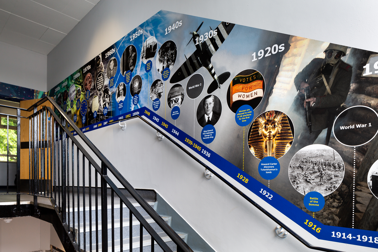 Image of school corridor featuring a historical wall art feature